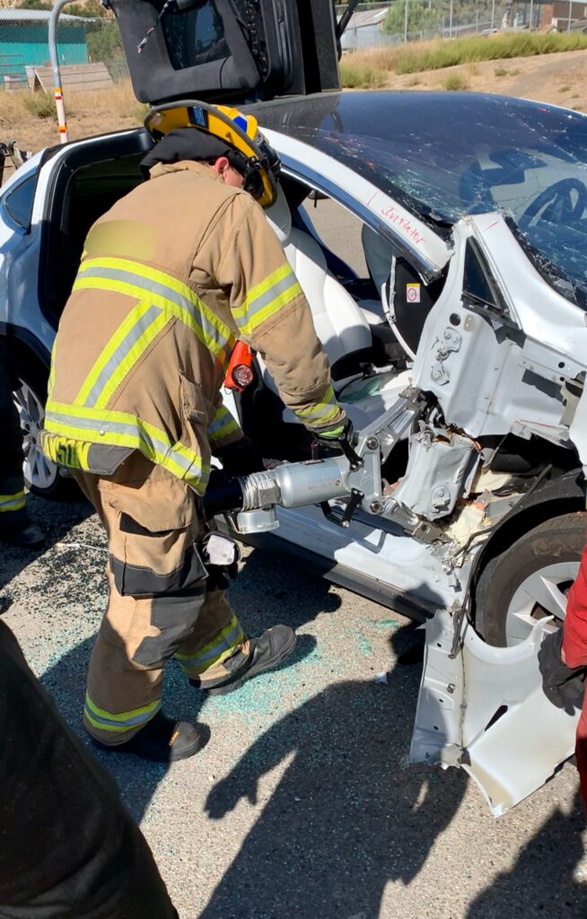 Auto extrication EV specialist cutting a Tesla Model X